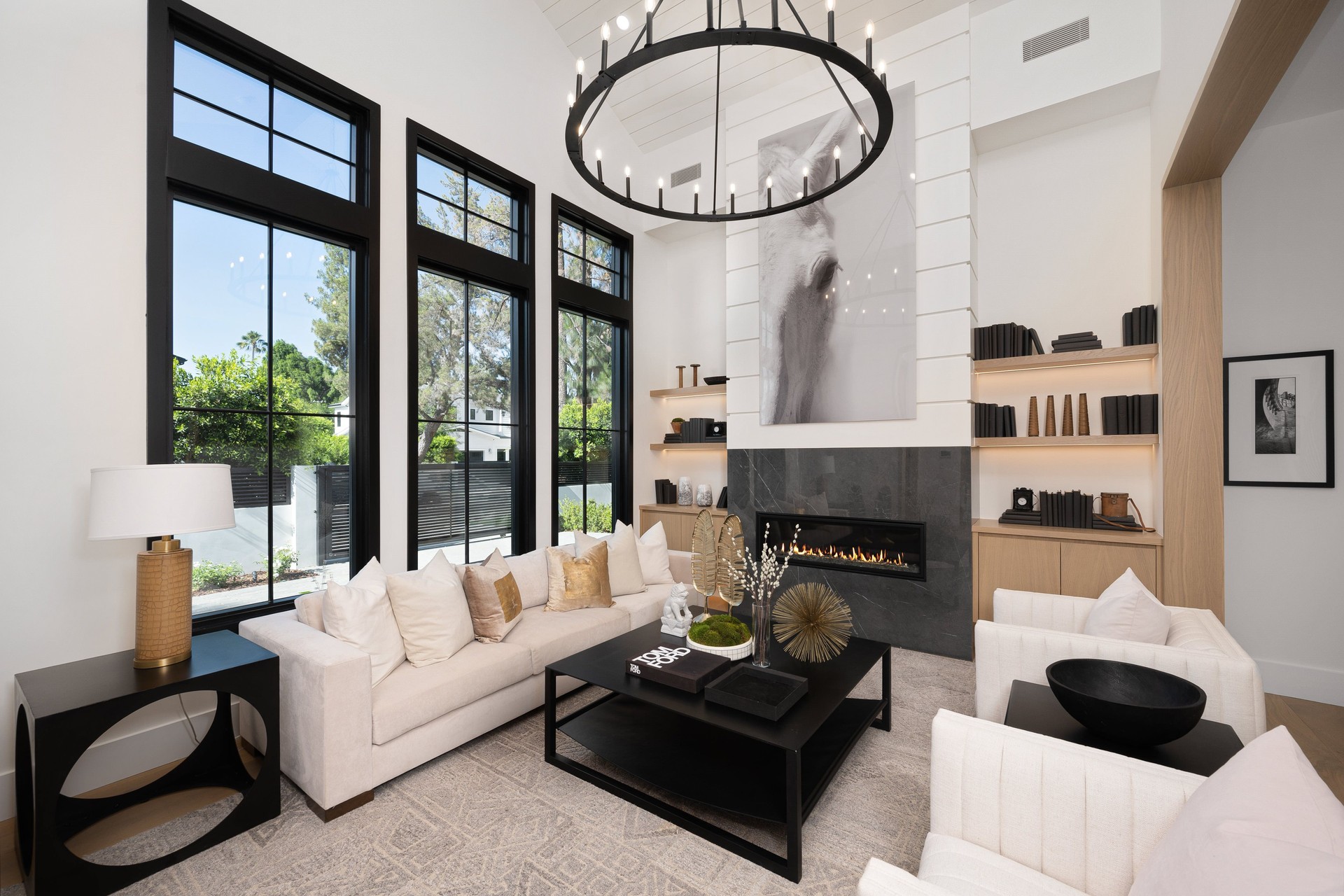 Stylish modern living room with high ceilings and large windows.